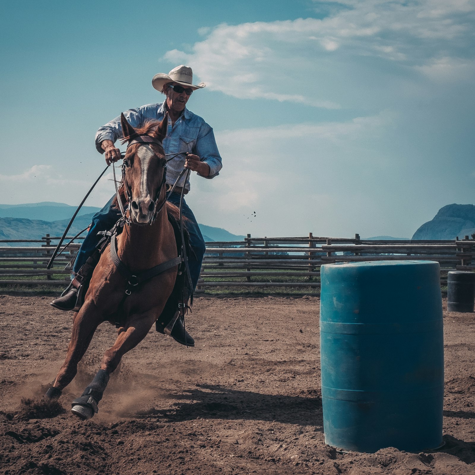 A man turning a horse hard in a western hat